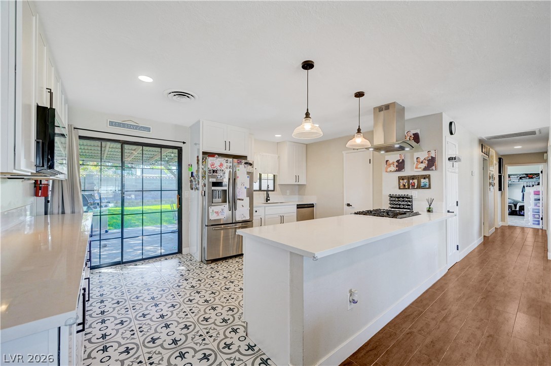 1331 Pinto Road Boulder City, NV 89005 - Photo 19 of 46 A well-equipped kitchen boasts an island with a gas range and sleek stainless steel appliances.