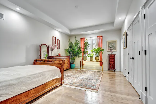 a bedroom with a large bed and a large window