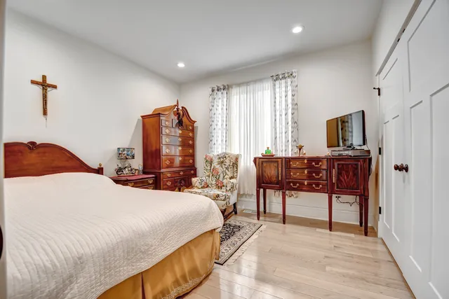 a bedroom with a bed and a chandelier