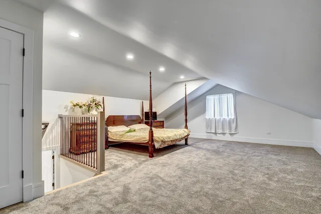 a spacious bedroom with a bed and window