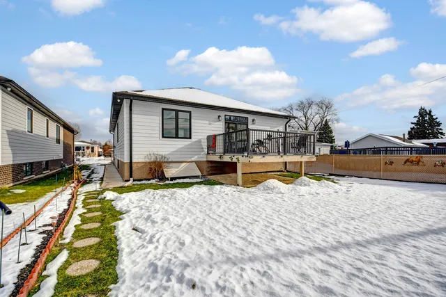 a view of a house with snow on the side of road