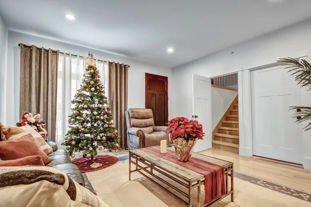 a living room with furniture and a potted plant