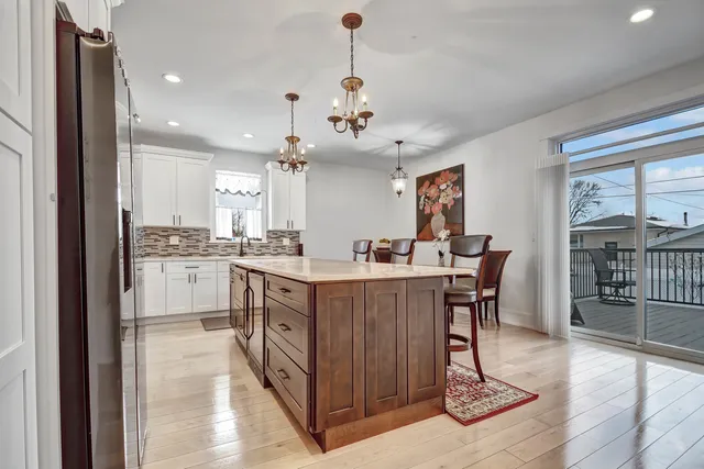 a kitchen with sink cabinets and dining table