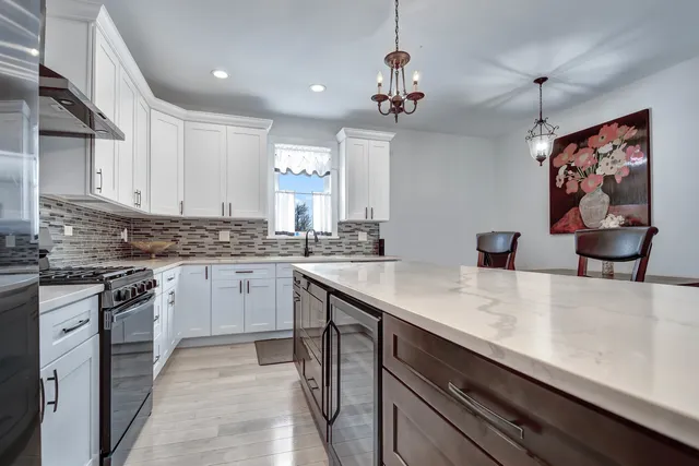 a kitchen with a sink stainless steel appliances and cabinets