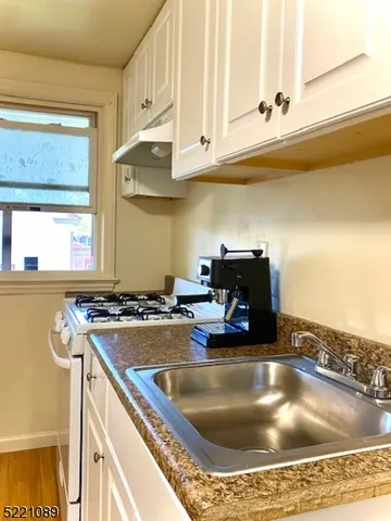 a kitchen with a sink a counter and appliances