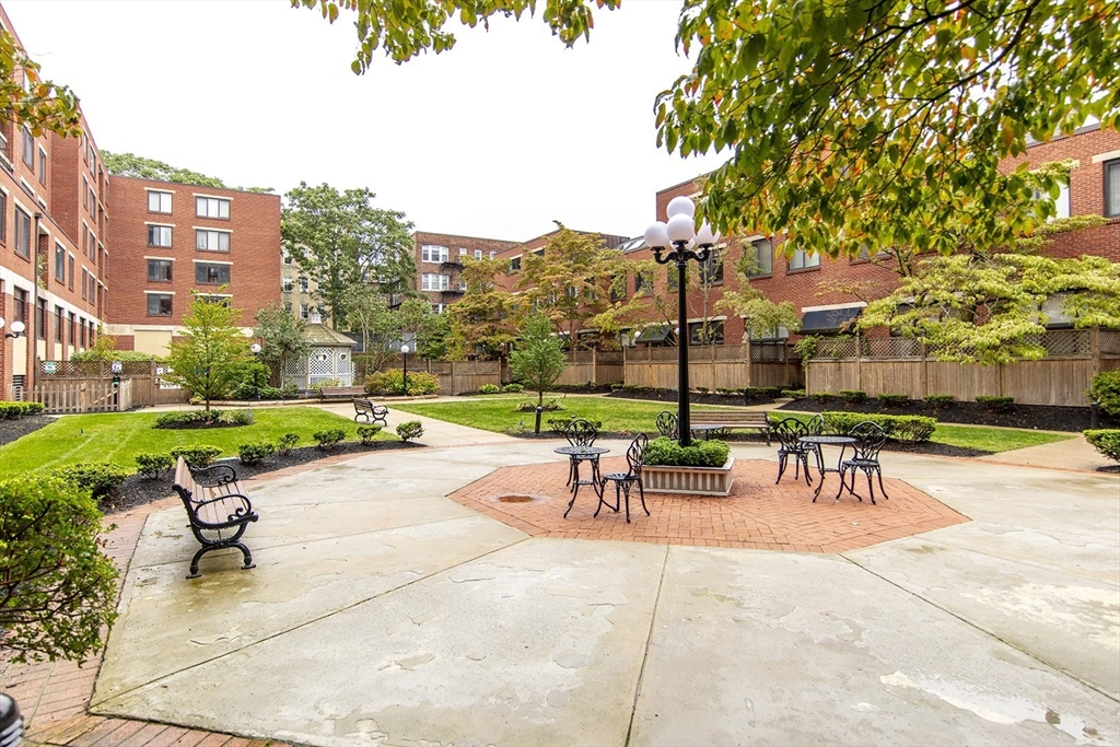 85 Brainerd Road, Unit 503 Boston, MA 02134 - Photo 18 of 21 a view of a patio with a table and chairs