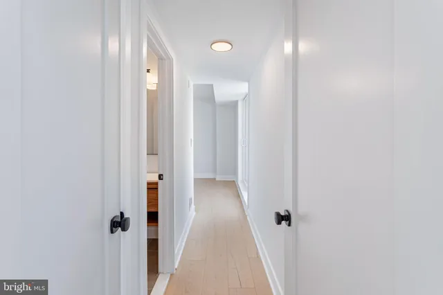 a view of a hallway with wooden floor