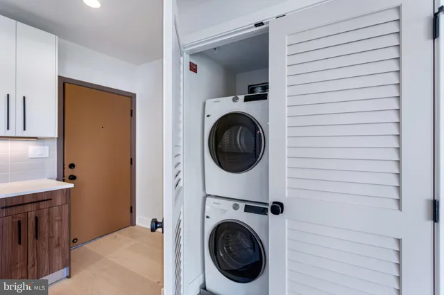 a view of a hallway with washer and dryer