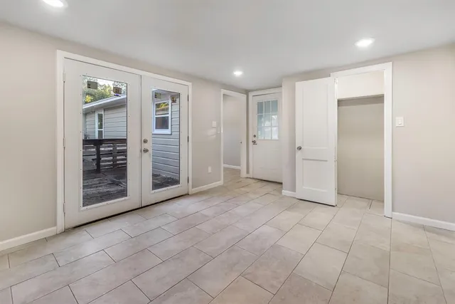 a view of backyard with wooden stairs and a large tree