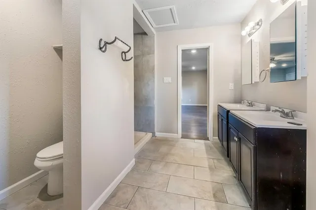 an empty room with fan and windows