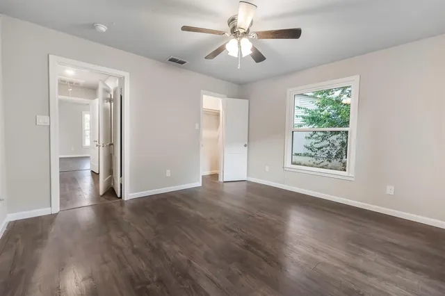 a view of an empty room with wooden floor