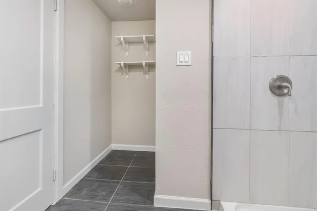 a view of a room with storage and racks on wall