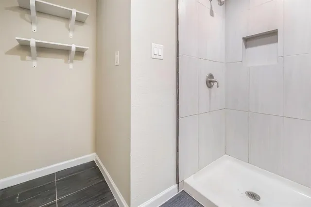 an aerial view of house with yard and mountain view in back