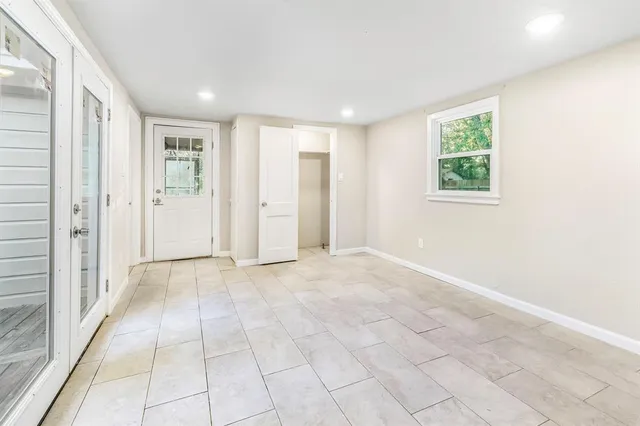 an empty room with windows and closet