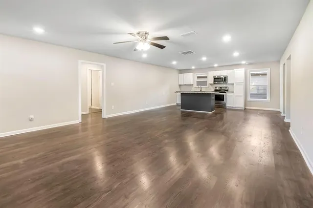 a view of a kitchen with a sink and microwave