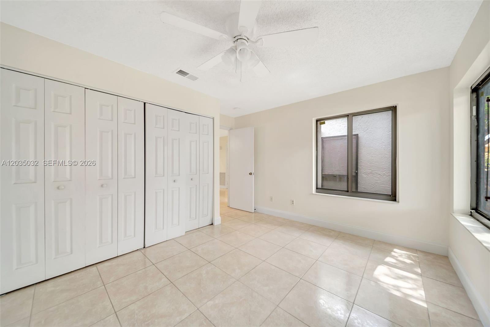 5223 Gate Lake Road, Unit 5223 Tamarac, FL 33319 - Photo 5 of 37 a view of an empty room with a window