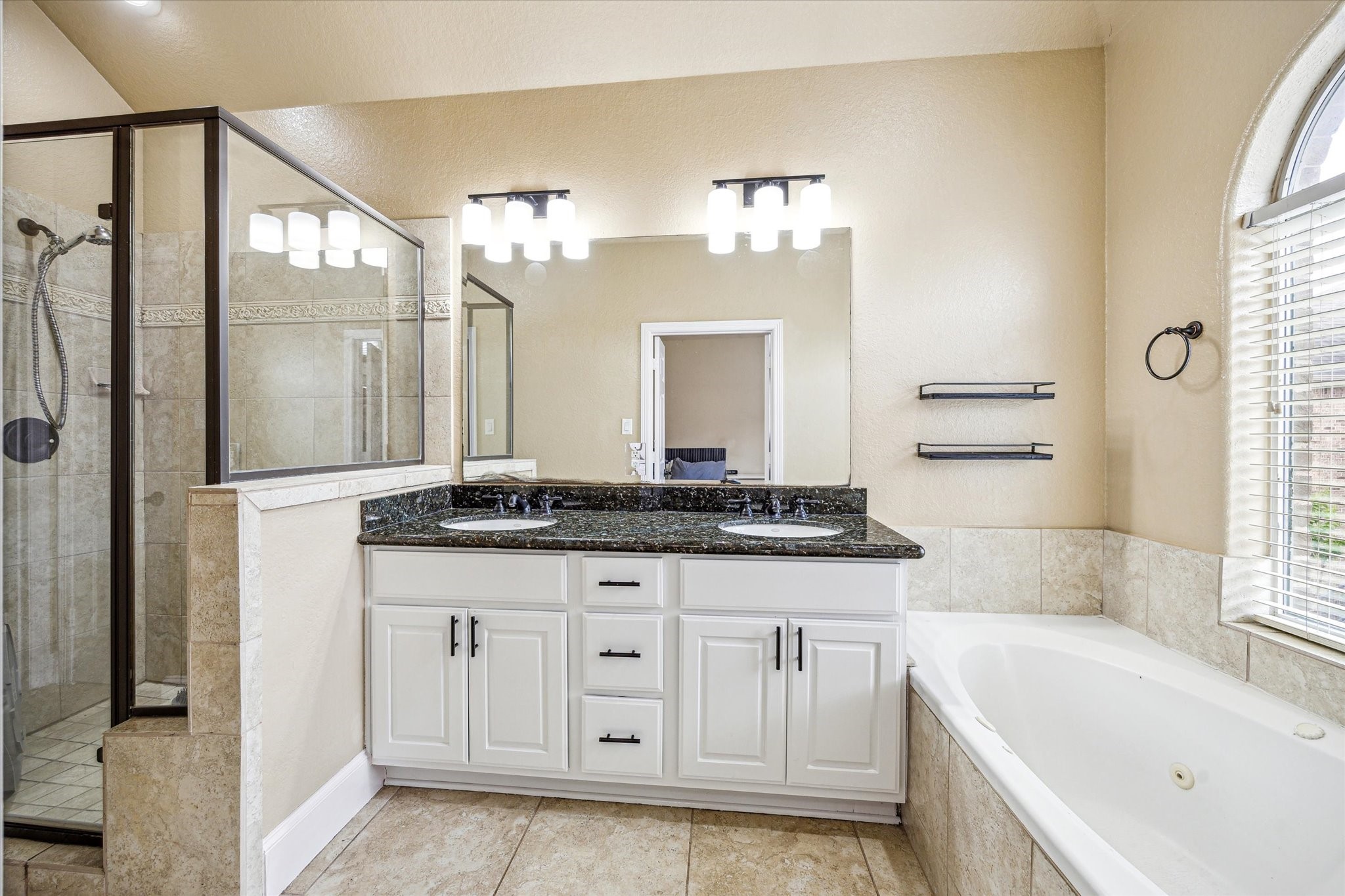 210 Grove Street Houston, TX 77020 - Photo 14 of 28 a bathroom with a granite countertop sink a large mirror and a bathtub with shower