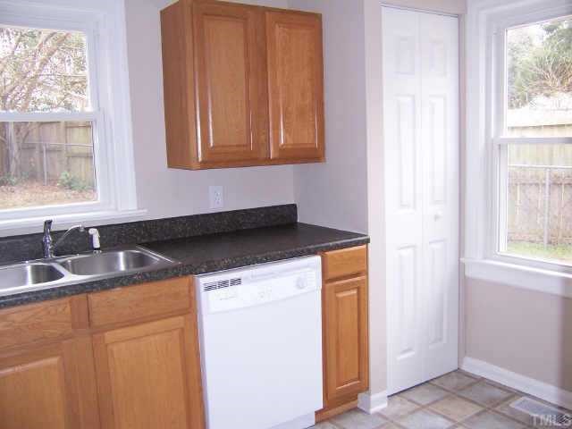 824 North King Charles Road Raleigh, NC 27610 - Photo 4 of 7 a kitchen with a sink a window and cabinets