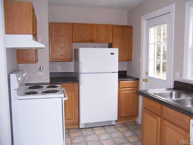 824 North King Charles Road Raleigh, NC 27610 - Photo 5 of 7 a kitchen with a refrigerator sink stove and cabinets