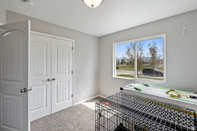 444 South Saddle Road Grantsville, UT 84029 - Photo 10 of 33 Bedroom with light colored carpet and a closet
