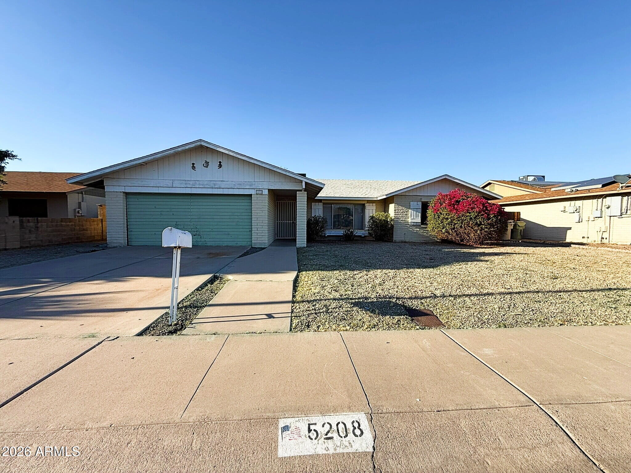 5208 West Calavar Road Glendale, AZ 85306 - Photo 27 of 39 a front view of a house with a yard