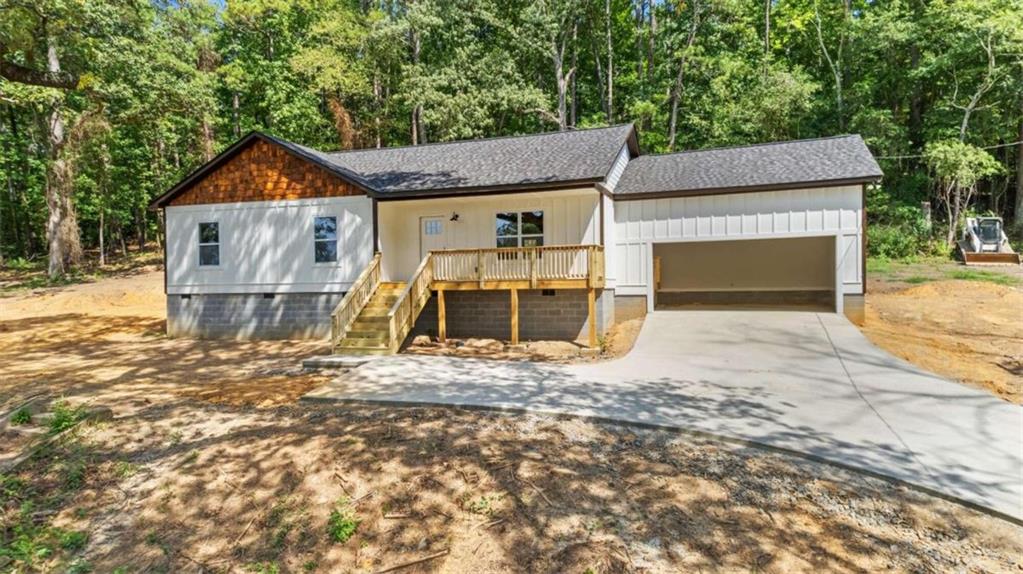 239 Blacks Bluff Road Southwest Rome, GA 30161 - Photo 1 of 1 a wooden house with wooden fence next to a road
