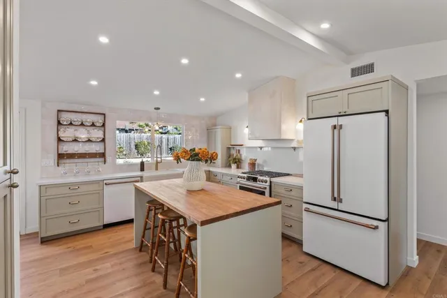 a kitchen with white cabinets and white appliances