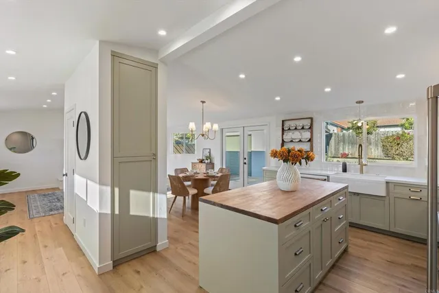 a kitchen with stainless steel appliances granite countertop a sink and a refrigerator