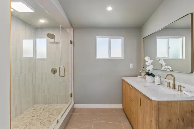 a bathroom with a sink a shower and a mirror
