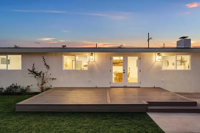 a room with pool table and windows