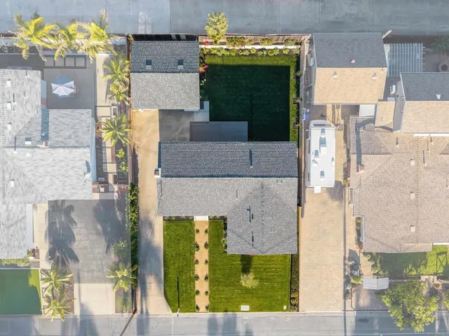 an aerial view of a house with a yard