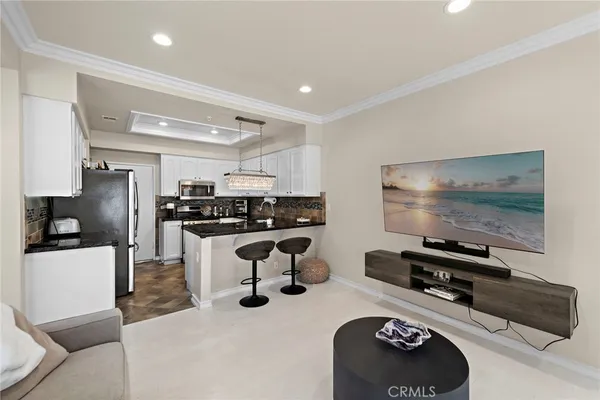 a kitchen with stainless steel appliances kitchen island granite countertop a refrigerator and a stove top oven