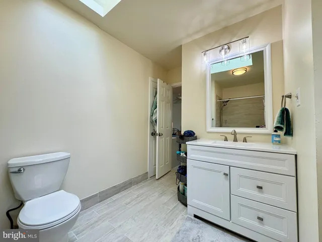 a bathroom with a toilet a sink and mirror
