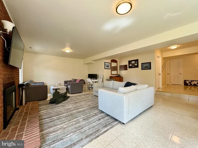 a living room with couches and a flat screen tv