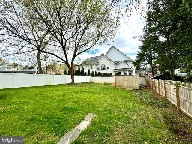 a view of a house with backyard and tree
