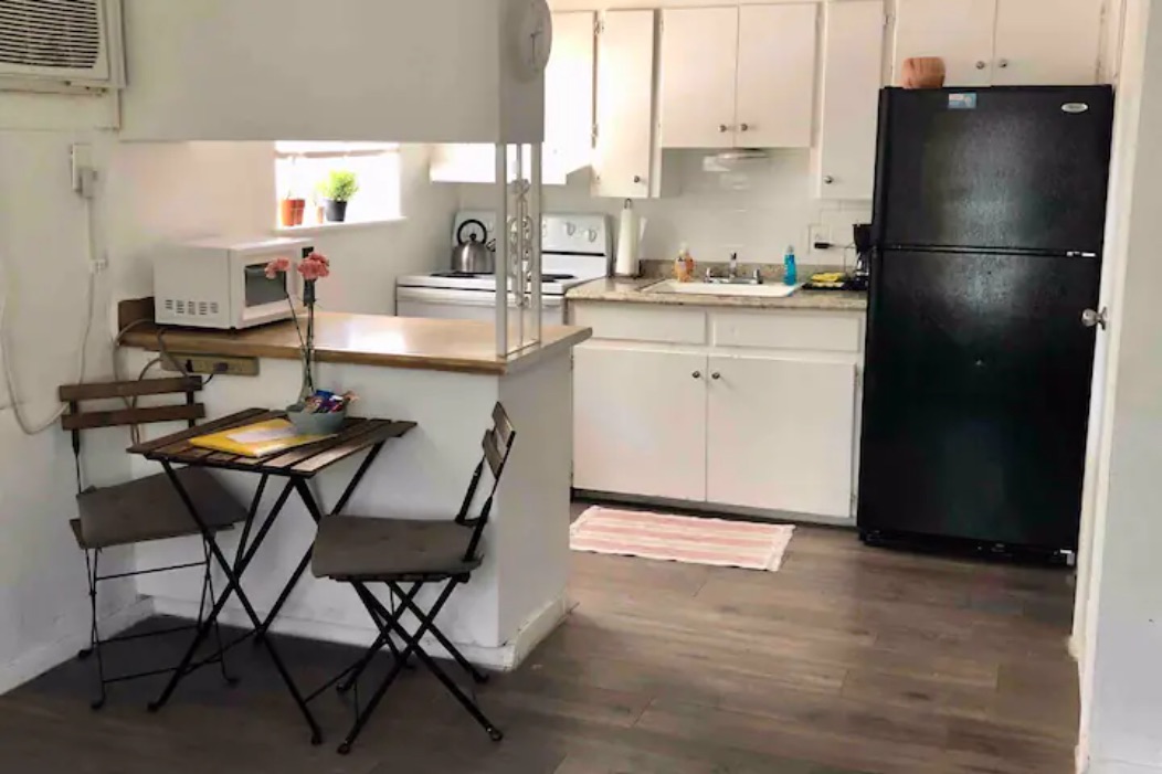 5909 Bolm Road, Unit 2 Austin, TX 78721 - Photo 6 of 10 a kitchen with a refrigerator a stove a sink and a cabinets