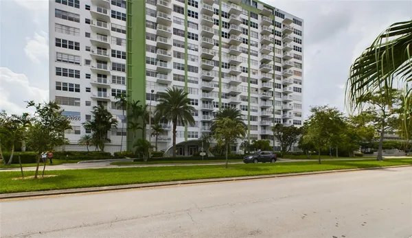 a garden with tall buildings