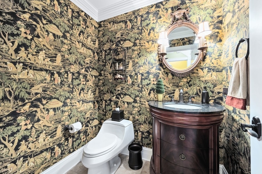 632 Chatham Road Glenview, IL 60025 - Photo 19 of 52 a bathroom with a sink a toilet and a mirror