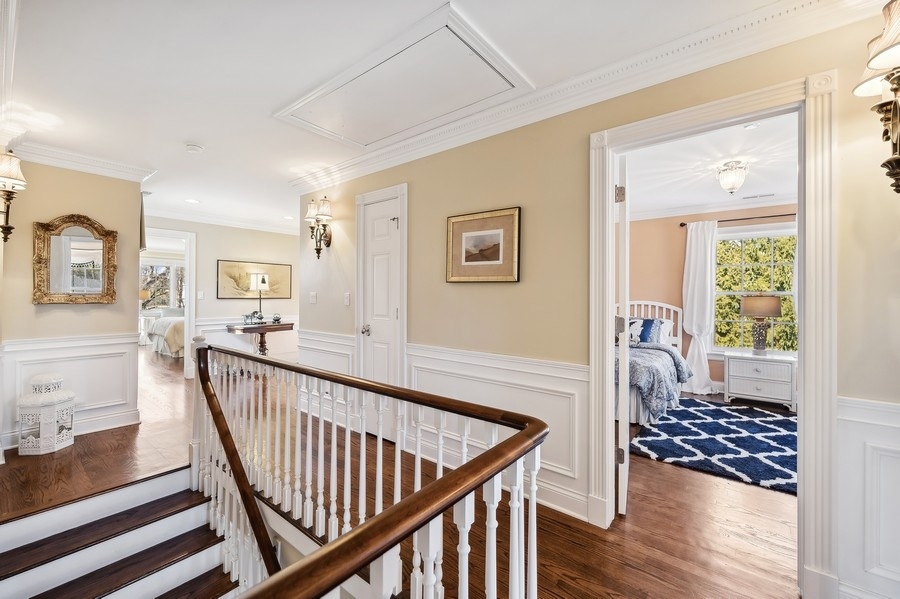 632 Chatham Road Glenview, IL 60025 - Photo 20 of 52 a view of a hallway to a livingroom with wooden floor and furniture