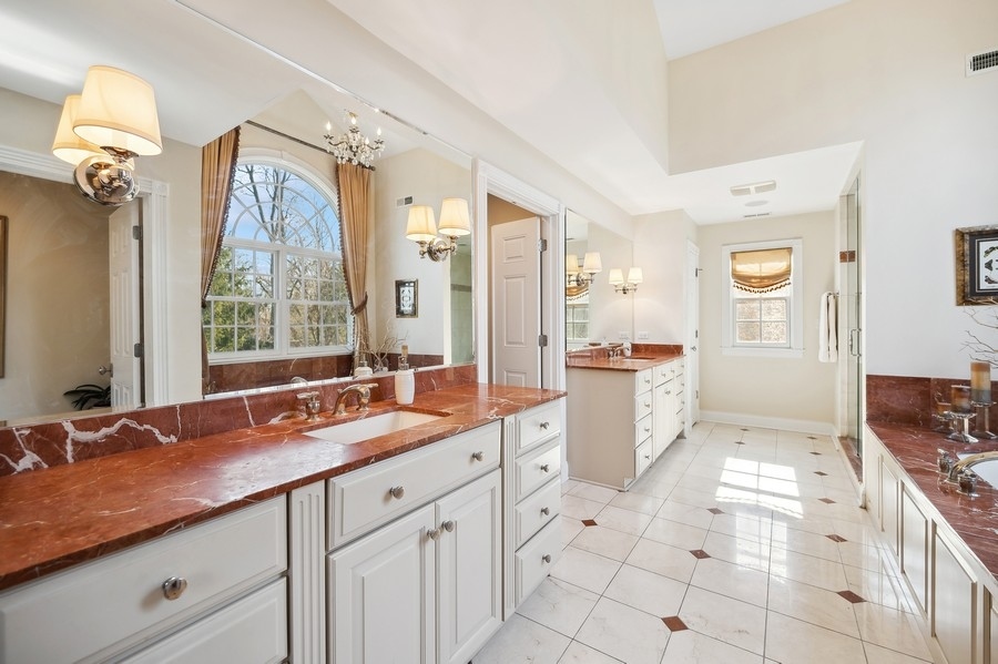 632 Chatham Road Glenview, IL 60025 - Photo 22 of 52 a spacious bathroom with a granite countertop sink mirror and a