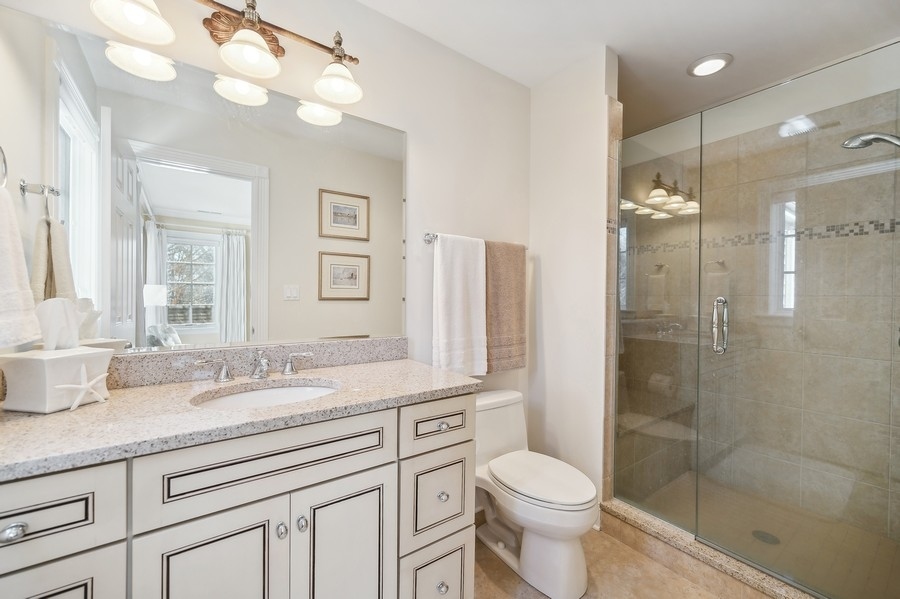 632 Chatham Road Glenview, IL 60025 - Photo 25 of 52 a bathroom with a granite countertop sink toilet and shower