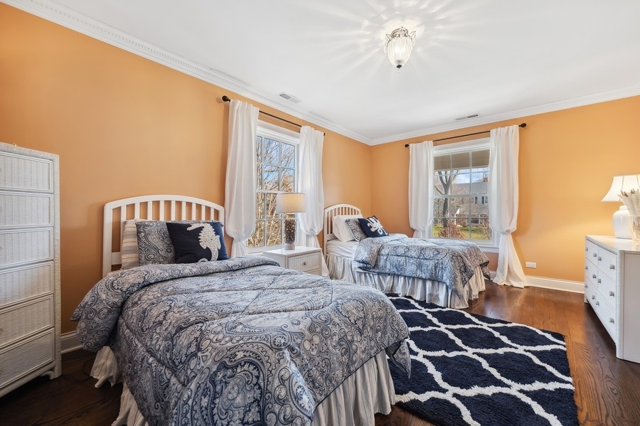 632 Chatham Road Glenview, IL 60025 - Photo 28 of 52 a bedroom with a bed and wooden floor