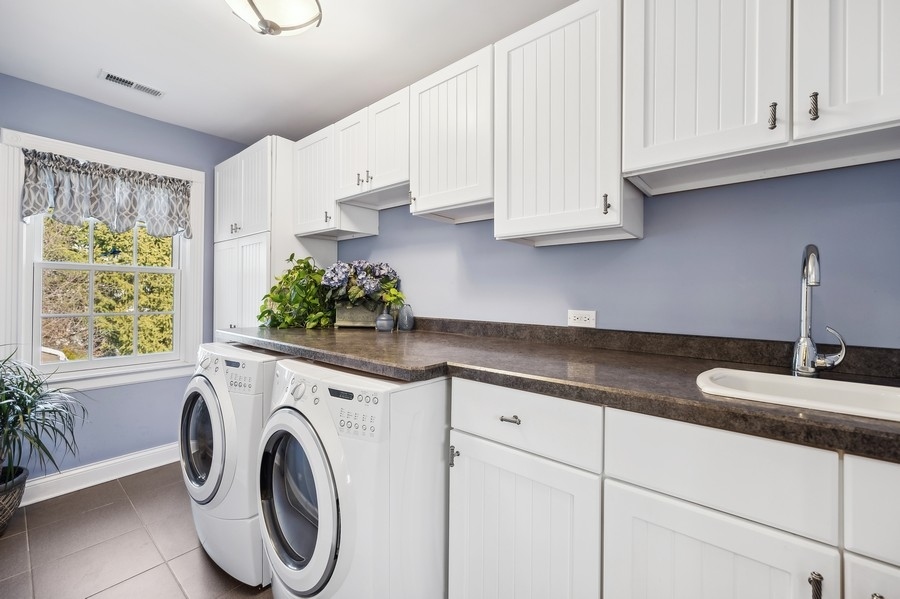 632 Chatham Road Glenview, IL 60025 - Photo 30 of 52 a kitchen with stainless steel appliances granite countertop a sink a stove and a white cabinets