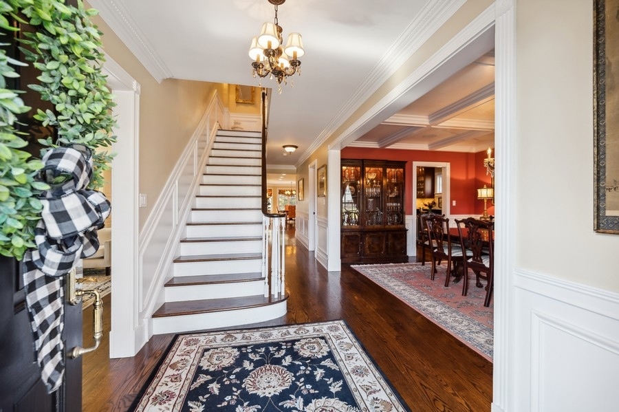 632 Chatham Road Glenview, IL 60025 - Photo 3 of 52 a large room with wooden floor windows and a chandelier