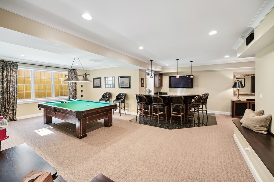632 Chatham Road Glenview, IL 60025 - Photo 31 of 52 a living room with furniture a table and kitchen view