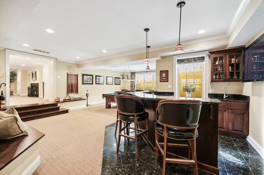 632 Chatham Road Glenview, IL 60025 - Photo 32 of 52 a living room with furniture a dining table and chairs