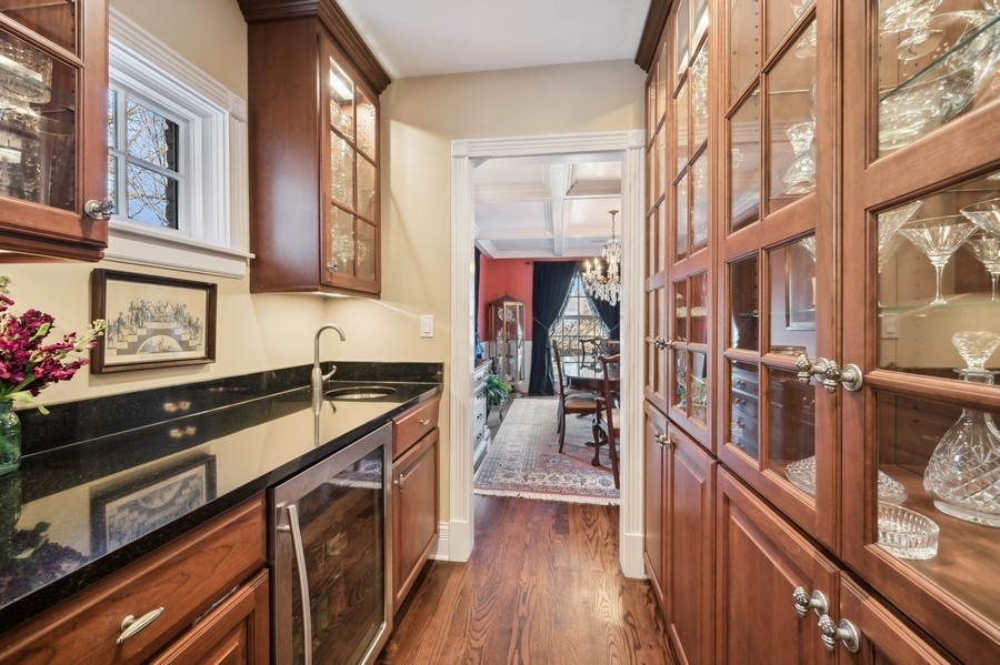 632 Chatham Road Glenview, IL 60025 - Photo 9 of 52 a kitchen with stainless steel appliances granite countertop a stove and a wooden floors