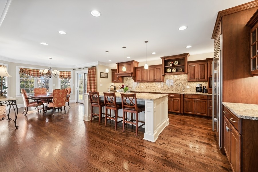 632 Chatham Road Glenview, IL 60025 - Photo 10 of 52 a kitchen with a table chairs sink and cabinets