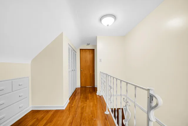 a view of hallway with wooden floor
