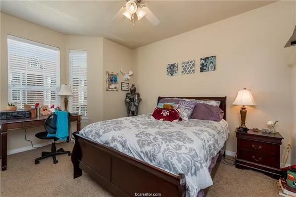 a bedroom with a bed and a table